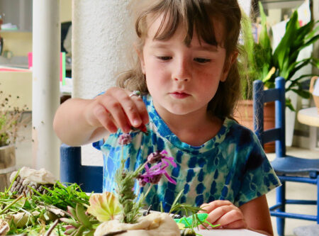 Kid playing with flowers and food